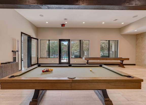 pool table in the clubhouse of a house with two pool tables