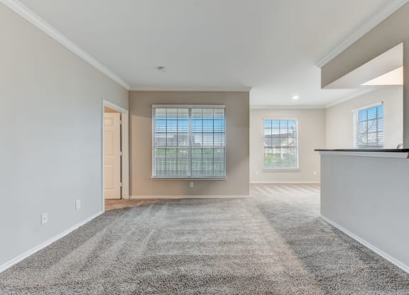 the spacious living room and dining room in a new home