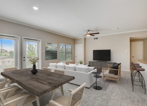 an open living room and dining room with a couch and a table at Artisan Apartments & Shops, Austin
