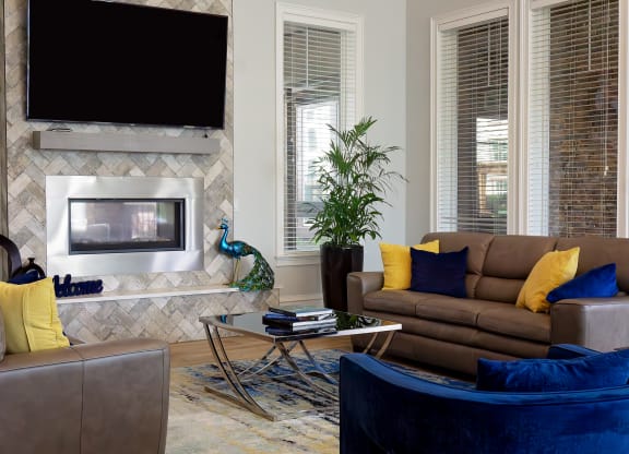 a living room with a fireplace and couches at The Oasis at Moss Park, Orlando