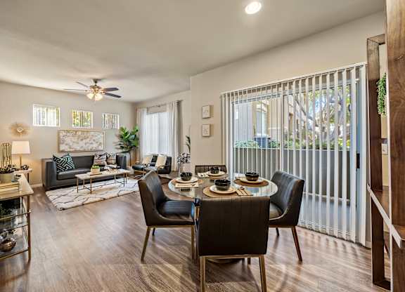 A modern living room with a dining table set for four.
