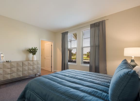 a bedroom with a large bed and two windows  at The Oasis at Manatee River, Florida, 34211