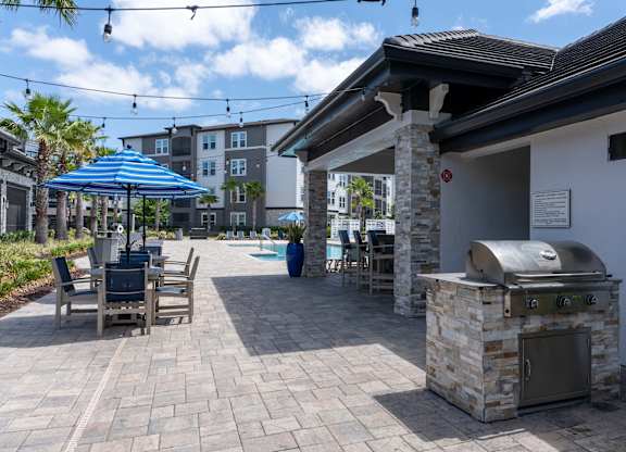Patio with a Grill at The Oasis at Town Center Apartments, Florida, 32246