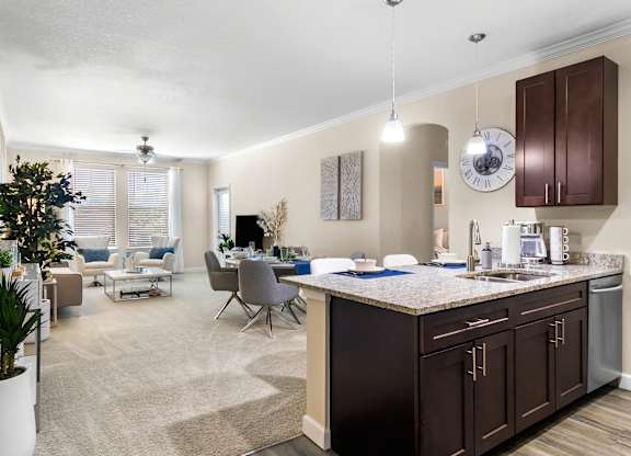 A modern kitchen with dark brown cabinets and a large island.