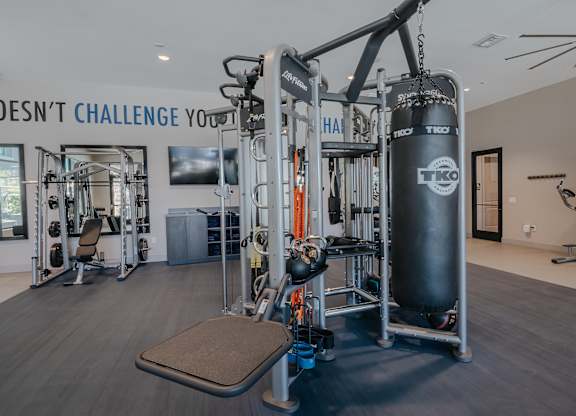 24-hour gym with multistation weight machine that includes a punching bag at Level 25 at The Curve by Picerne, Nevada