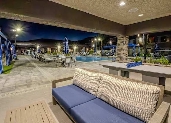 Patio furniture under the build in pool side ramada at Level 25 at The Curve by Picerne, Nevada
