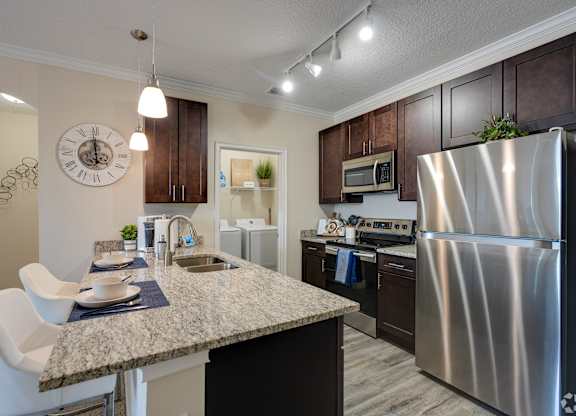 Kitchen with Granite Countertop at The Oasis at Town Center Apartments, Jacksonville, Florida