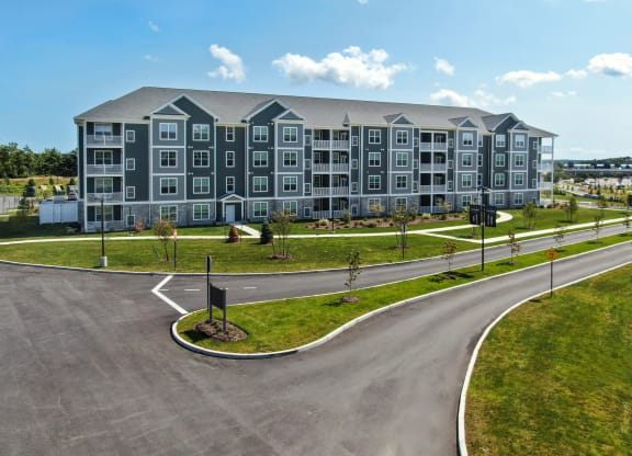 a large apartment building with a road in front of it at The Oasis at Plymouth, Massachusetts, 02360