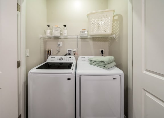 a white washer and dryer in a small laundry room at The Oasis at Plymouth, Plymouth, 02360