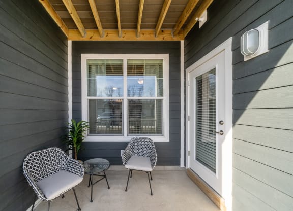 a covered porch with two chairs and a table at The Oasis at Plymouth, Plymouth, Massachusetts