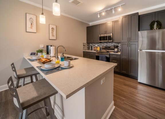 kitchen with island and stainless steel appliances at the preserve at great neck apartments at The Oasis at Plymouth, Plymouth, MA