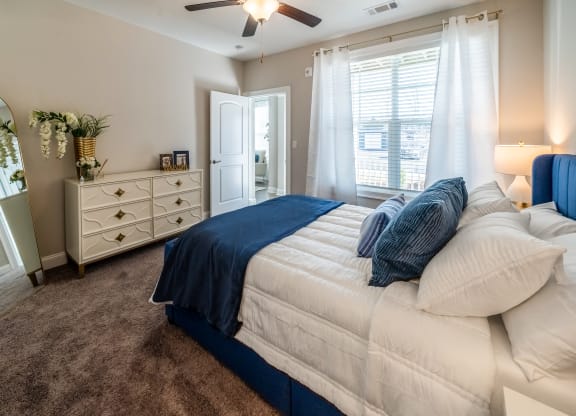 a bedroom with a bed and a dresser and a ceiling fan at The Oasis at Plymouth, Massachusetts