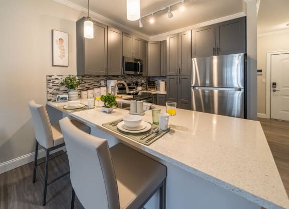 an open kitchen with stainless steel appliances and a large counter top at The Oasis at Plymouth, Massachusetts, 02360