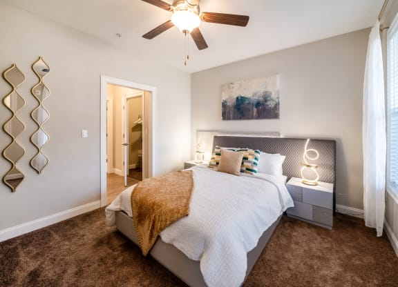a bedroom with a bed and a ceiling fan at The Oasis at Plymouth, Massachusetts