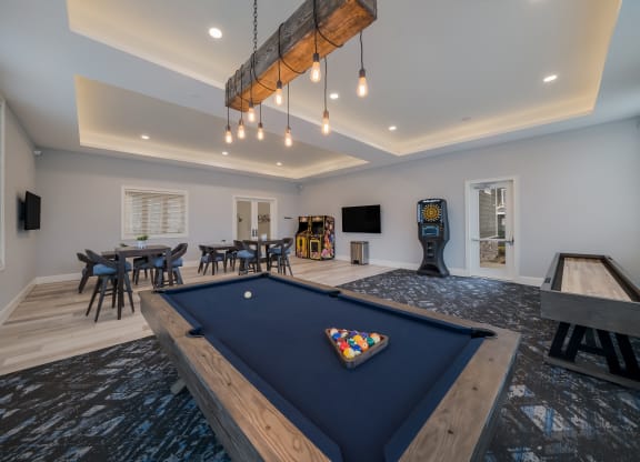 a game room with a blue pool table and a game system at The Oasis at Plymouth, Plymouth, 02360