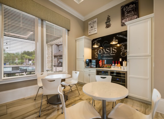 a dining room with tables and chairs and a bar at The Oasis at Highwoods Preserve, Tampa, 33647