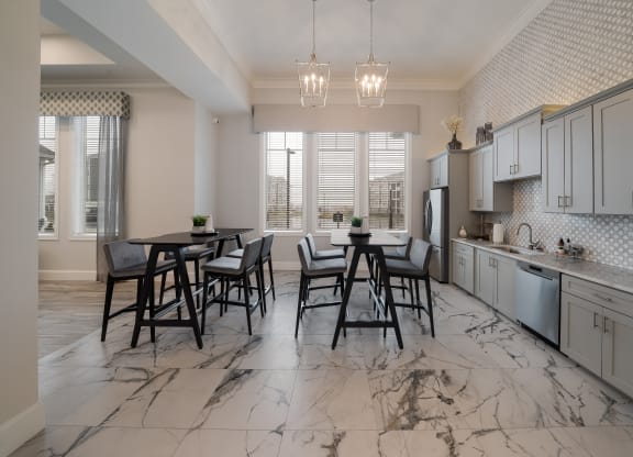 a kitchen and dining room with marble flooring and a table and chairs at The Oasis at Plymouth, Massachusetts