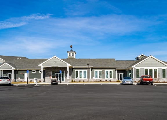 a large building with cars in a parking lot at The Oasis at Plymouth, Plymouth, MA