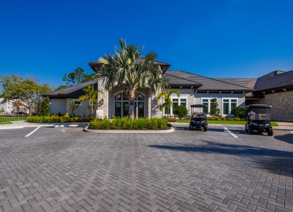 a large house with a driveway and palm trees in front of it  at The Oasis at Manatee River, Bradenton, FL, 34211