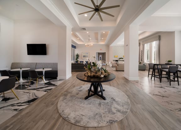 a living room with tables and chairs and a ceiling fan at The Oasis at Plymouth, Plymouth, Massachusetts