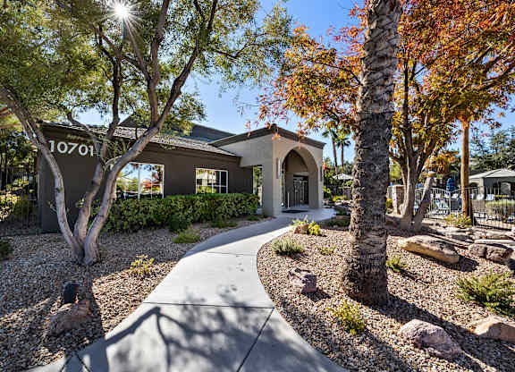 A house numbered 10701 is surrounded by trees and rocks.