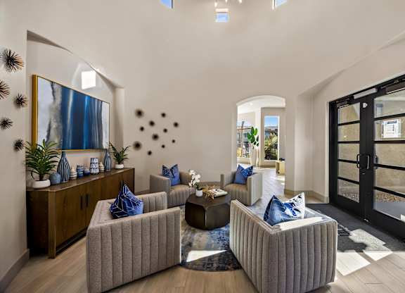 A modern living room with a large mirror, a wooden cabinet, and a grey sofa.