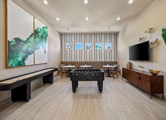 A room with a pool table and a painting on the wall.