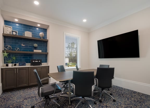 a meeting room with a table and chairs and a flat screen tv  at The Oasis at Manatee River, Florida