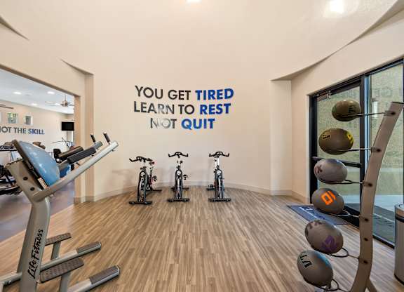 A gym with a motivational quote on the wall.