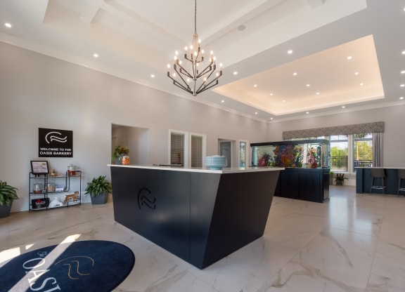 a modern reception desk with a chandelier hanging from the ceiling  at The Oasis at Manatee River, Florida, 34211