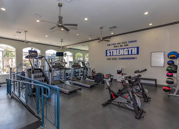 A gym with a sign that says "The pain you feel today will be the strength you feel tomorrow!"