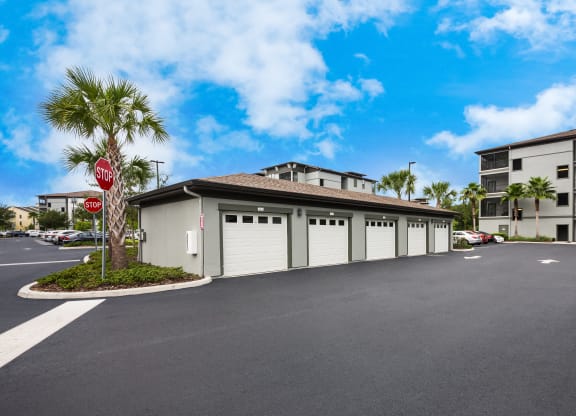 a garage with a stop sign in front of a building at The Oasis at Highwoods Preserve, Tampa, FL, 33647