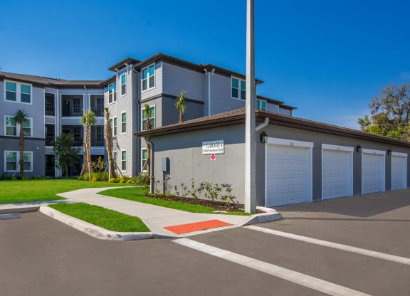 a building with a garage and a street sign in front of it  at The Oasis at Manatee River, Bradenton, FL, 34211