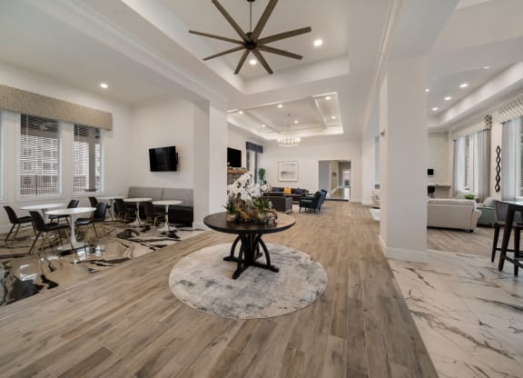 a large living room with a ceiling fan and a round table at The Oasis at Plymouth, Plymouth, MA