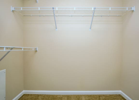 a walk in closet in an empty room with white shelves at Loreto & Palacio Apartments, Las Vegas, 89149