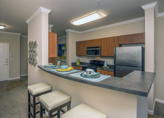 a kitchen with high counter top and a sink and a refrigerator at Loreto & Palacio Apartments, Las Vegas, 89149