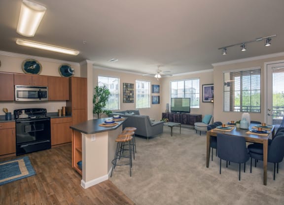 an open living room and kitchen with a dining room table and chairs at Loreto & Palacio Apartments, Las Vegas