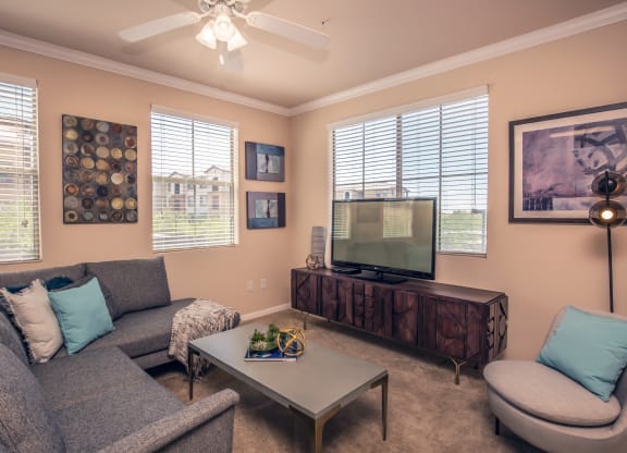 a living room with a couch and a television at Loreto & Palacio Apartments, Las Vegas, Nevada