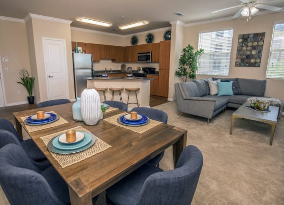 a dining room and living room with a table and chairs at Loreto & Palacio Apartments, Las Vegas, NV