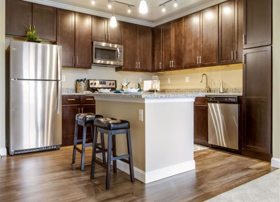 Kitchen with wooden cabinets at The Oasis at Plainville, Plainville, 02762