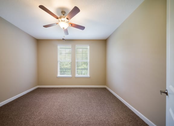 an empty room with a ceiling fan and a window at The Oasis at Highwoods Preserve, Tampa