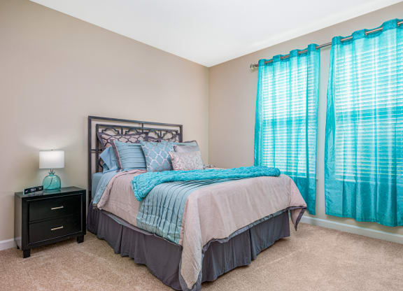 Bedroom with cozy bed with curtains at The Oasis at Crosstown, Orlando