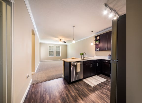an open kitchen and living room with a refrigerator and a sink at The Oasis at Highwoods Preserve, Tampa, 33647