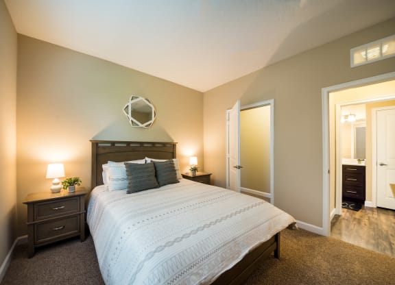 a bedroom with a large bed and a mirror at The Oasis at Highwoods Preserve, Tampa, FL