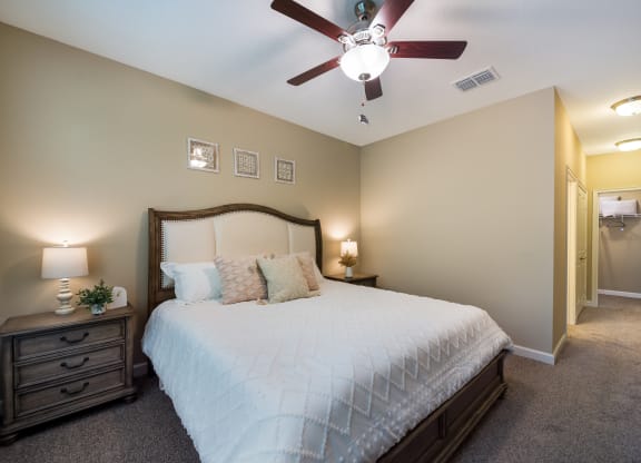 a bedroom with a large bed and a ceiling fan at The Oasis at Highwoods Preserve, Tampa, FL