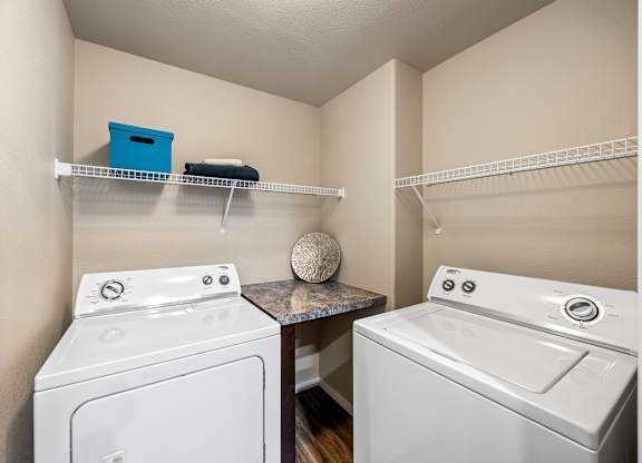 A small laundry room with a washer and dryer.