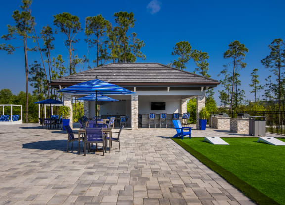 a large pavilion with a seating area and a bar  at The Oasis at Manatee River, Bradenton