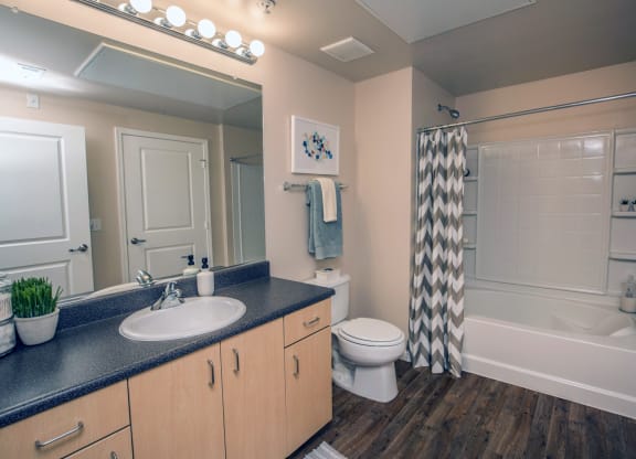 a bathroom with a shower toilet and sink and a mirror at Loreto & Palacio Apartments, Las Vegas, NV 89149