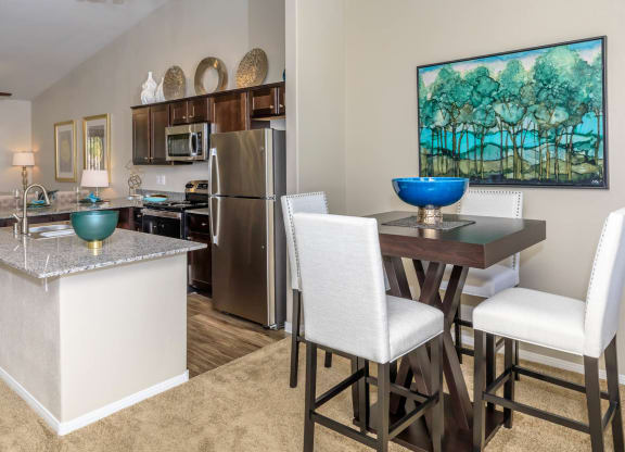 Kitchen wide view with cabinets and appliances with dining at The Cantera by Picerne, Las Vegas, NV, 89139