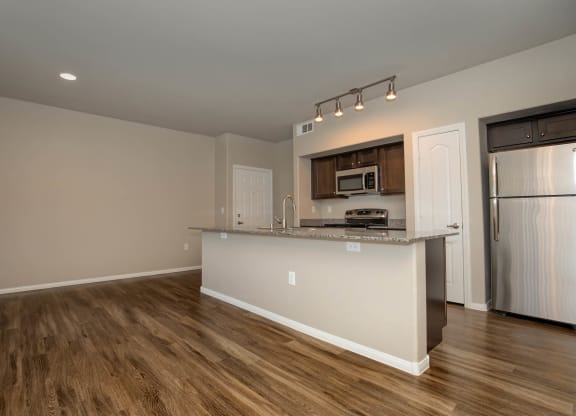 wooden cabinets and appliances in kitchen and dining area1 at The Cantera by Picerne, Las Vegas, 89139